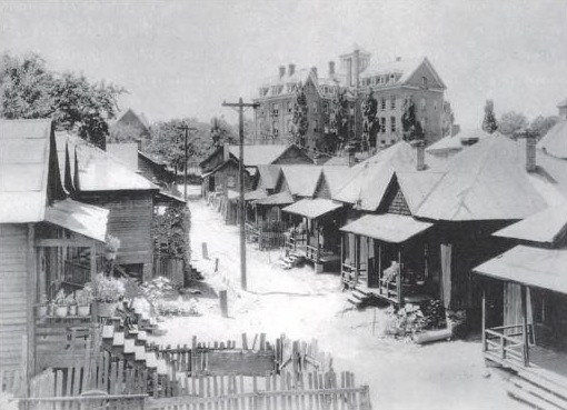 Wood-frame houses in the Beaver Slide neighborhood, with Atlanta University Center in the background, 1934